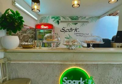 On-site café counter with Spark branding, decorative lighting, and a refreshments display.