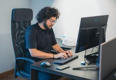 Modern workstation with an ergonomic chair and dual monitor setup.
