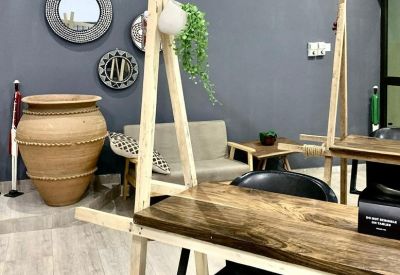 Coworking space with unique wooden A-frame desks and a large decorative pot.