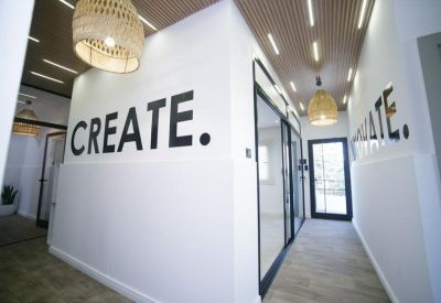 Modern corridor with large text wall art and stylish wicker pendant lighting.