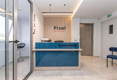 Modern reception area with a sleek blue front desk and branded wood-paneled wall.