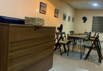 Reception counter made of dark wood grain panels in a well-lit entrance area.