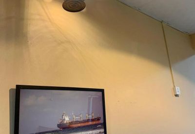 Interior wall detail showing a vintage lantern-style light fixture and framed artwork.