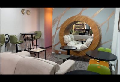 Modern breakout area with a unique circular wooden seating portal and vibrant lime green chairs.