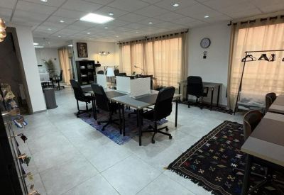 Coworking area showing various seating arrangements and patterned floor rugs.