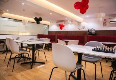 Casual seating area featuring wooden floors and a chessboard on a table.