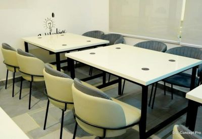 Meeting room at State Library, Stadium Poolside, Calabar, Nigeria with white tables and modern beige and grey chairs.