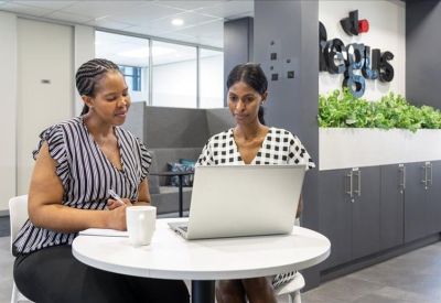 Cozy lounge area with sofas and a wall clock.