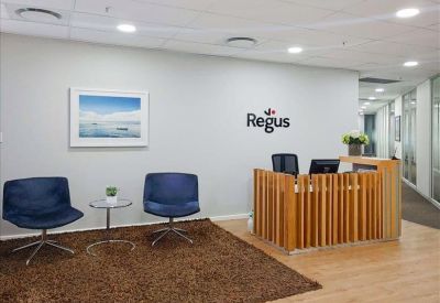 Modern reception area with a wooden slat desk and branded wall.