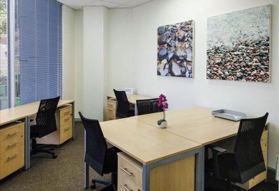 Private office suite with two desks and abstract wall art.