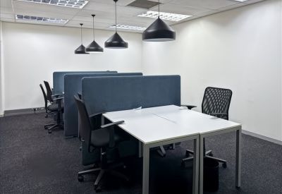 Quiet workspace with grey privacy dividers and black ergonomic chairs.