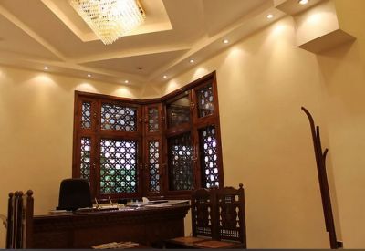 Private office suite featuring a decorative wooden desk and traditional window lattice.