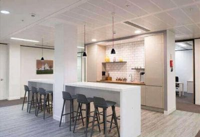 Breakout area with bar seating and a modern kitchenette.