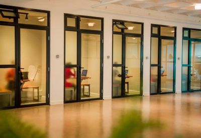 Row of private glass-door phone booths for quiet calls.