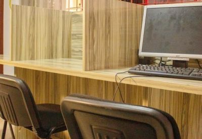 Dedicated workstation area with light wood partitions and a desktop computer.