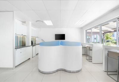 Bright communal kitchen area with a curved white breakfast bar.
