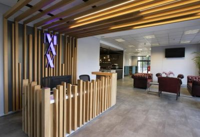 Modern reception desk with wooden slat feature wall and branded signage.