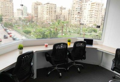 Bright workspace at 15 Sakaliya Street, Makram Ebeid, Nasr City, Cairo with window desks overlooking a green park.