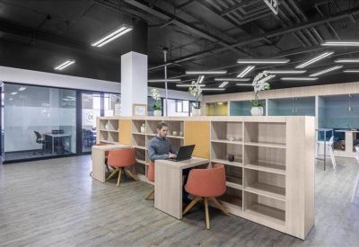 Contemporary breakout space with wooden room dividers and colorful seating.