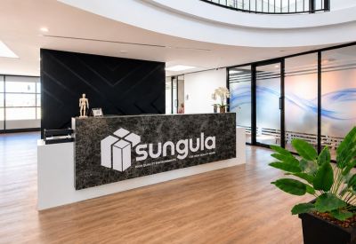 Modern reception area with a dark marble desk and branded signage.