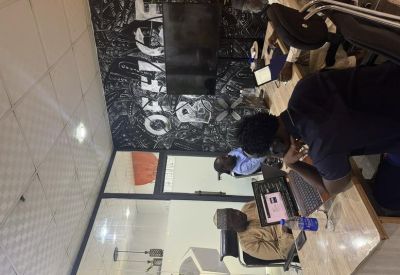 Open-plan workspace with professionals at desks featuring a large typographic feature wall.