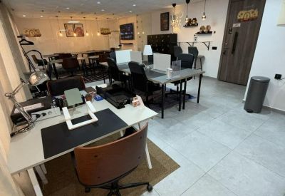 Modern coworking interior with various seating options and warm spotlighting.