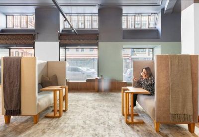Private high-backed seating booths for focused work or phone calls.
