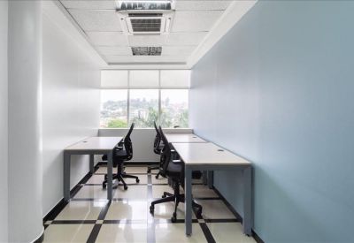 Long internal office suite with multiple workstations and blue accent wall.