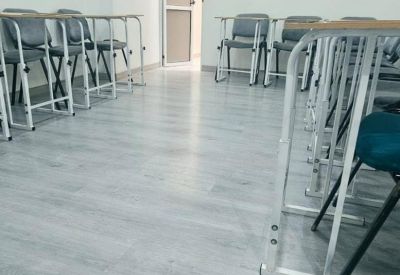 Empty classroom or training room with rows of individual desks and chairs.