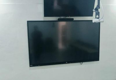 Training room wall featuring two mounted flat-screen monitors.