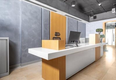 Sleek reception desk with wood paneling and a minimalist white counter.