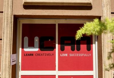 Entrance of UCAN Connect, Building 30, Street 200, Degla Maadi, Cairo featuring red and white welcome signage.