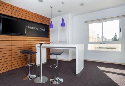 Communal kitchen area with high tables and chairs