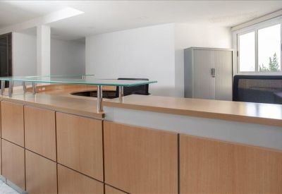 Reception area with a wooden front desk and glass partition