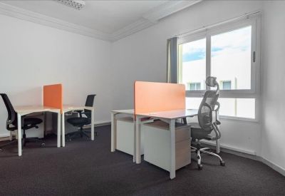 Office space with desks featuring orange privacy panels