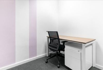 Small private office with a single desk and chair.