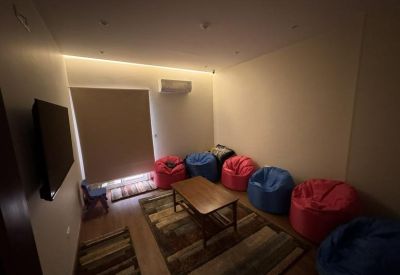 Casual breakout room with colorful red and blue bean bags around a central coffee table.