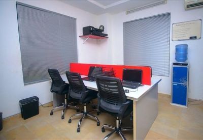 Workstation area with blue water dispenser and red privacy dividers.