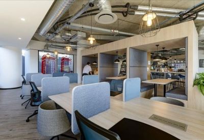 Bright coworking space featuring individual privacy booths and modern light fixtures.