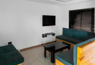 Lounge area with sofas and wall-mounted TV.