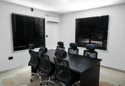 Conference room with a large table and six chairs.