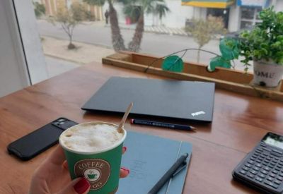 Desk with coffee and laptop overlooking the street from Immeuble El Bassatine, Avenue Egypte.