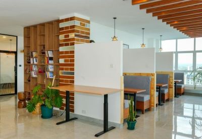 Communal break area featuring wooden privacy booths and a brick pillar.