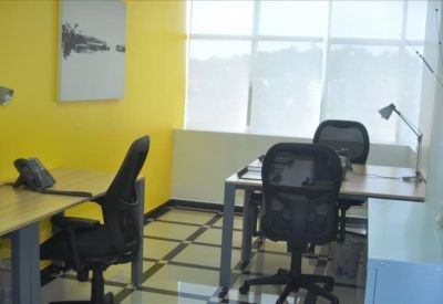 Open office area with yellow wall and ample natural light.