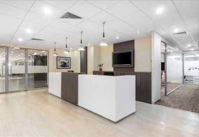 Modern reception desk with wood paneling and multiple designer pendant lights.