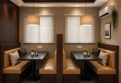 Cozy breakout booth seating area with warm lighting and wooden accents.
