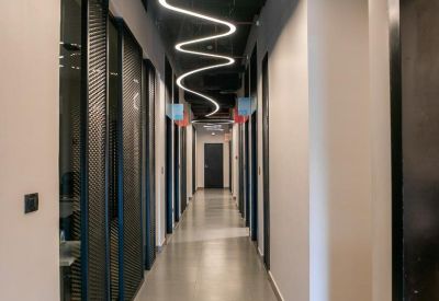 Modern hallway with a unique zigzagging linear light fixture on the ceiling.