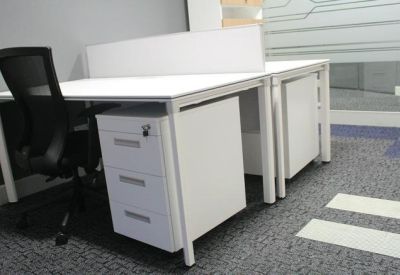 Modern white workstation featuring integrated storage and a mesh ergonomic chair.