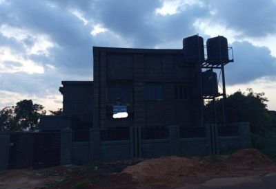 Landscape shot of the building exterior against a cloudy sky at dusk.