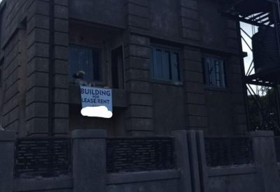 Exterior view of the Opposite Unique and Fine Secondary School, Umuchigbo Nike building with dark textured facade.